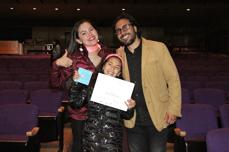 niña ganadora con sus padres