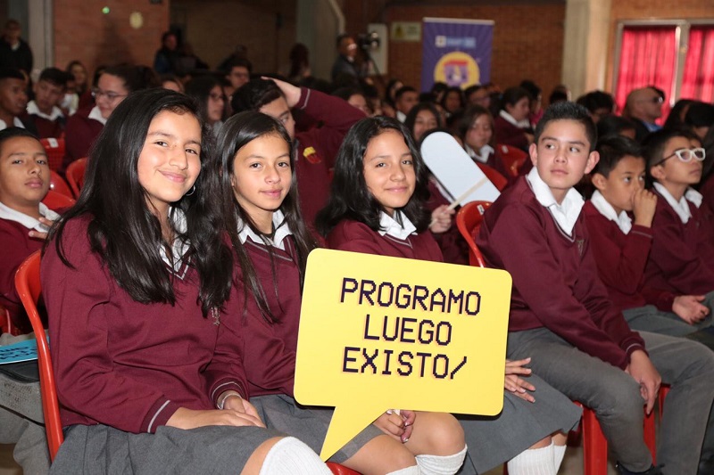 Estudiantes sosteniendo un aviso